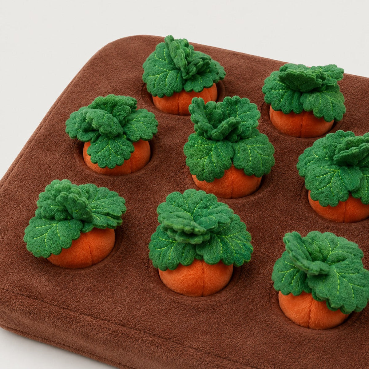 Close-up of plush carrots and soft fabric on dog snuffle mat