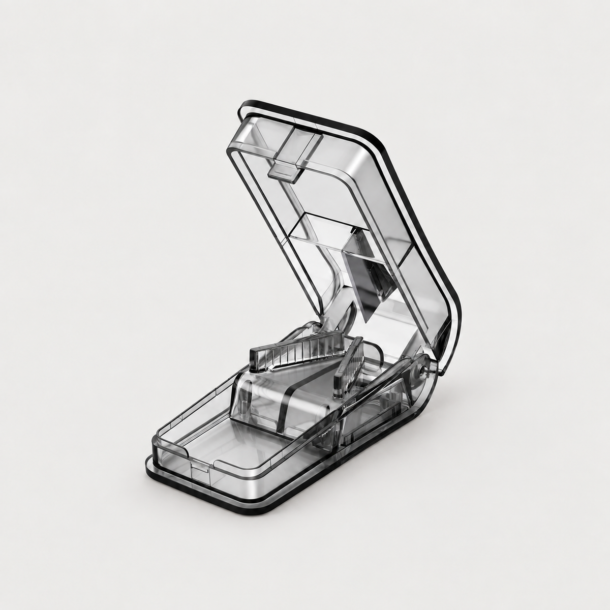 Black pet pill cutter and tablet splitter open on a neutral background