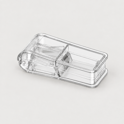 Pet pill cutter with a tablet split in half and one half in the storage tray