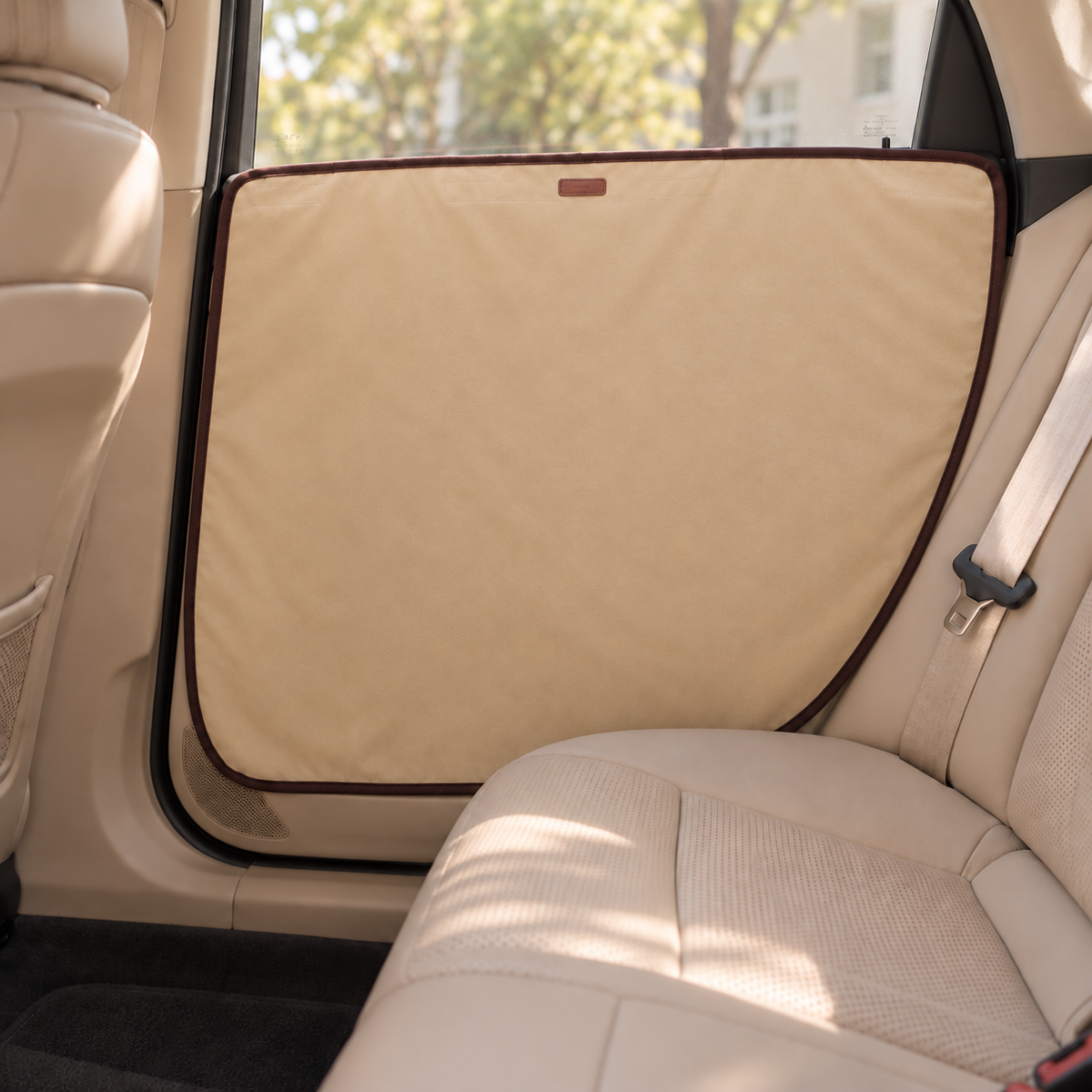Beige dog car door guard installed over door trim and recessed handle area