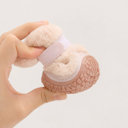 Flexible pink CozyStep dog boot bent by hand to show soft construction and grippy sole