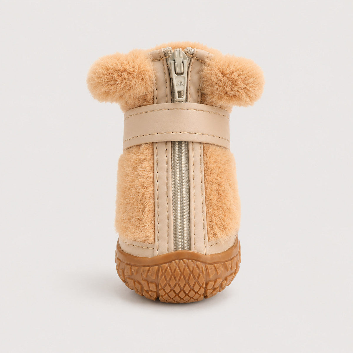 Close-up of CozyStep winter dog boot with front zipper, strap and textured traction sole