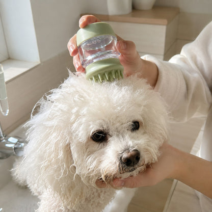 White dog being gently groomed with a silicone pet bath and massage brush