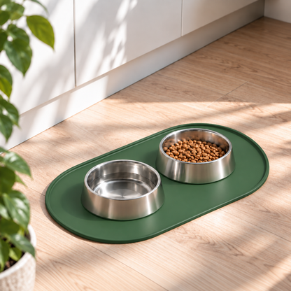 Dark green silicone dog feeding mat with stainless steel food and water bowls in a modern home