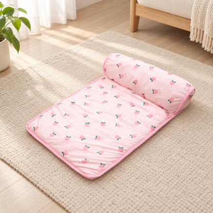 Pink ice silk cooling pet mat with padded pillow edge in natural window light