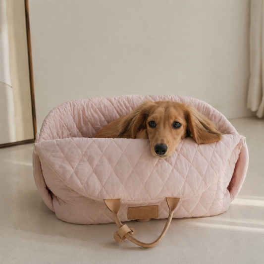 Small dog resting in a pink quilted comfort pet carrier bag