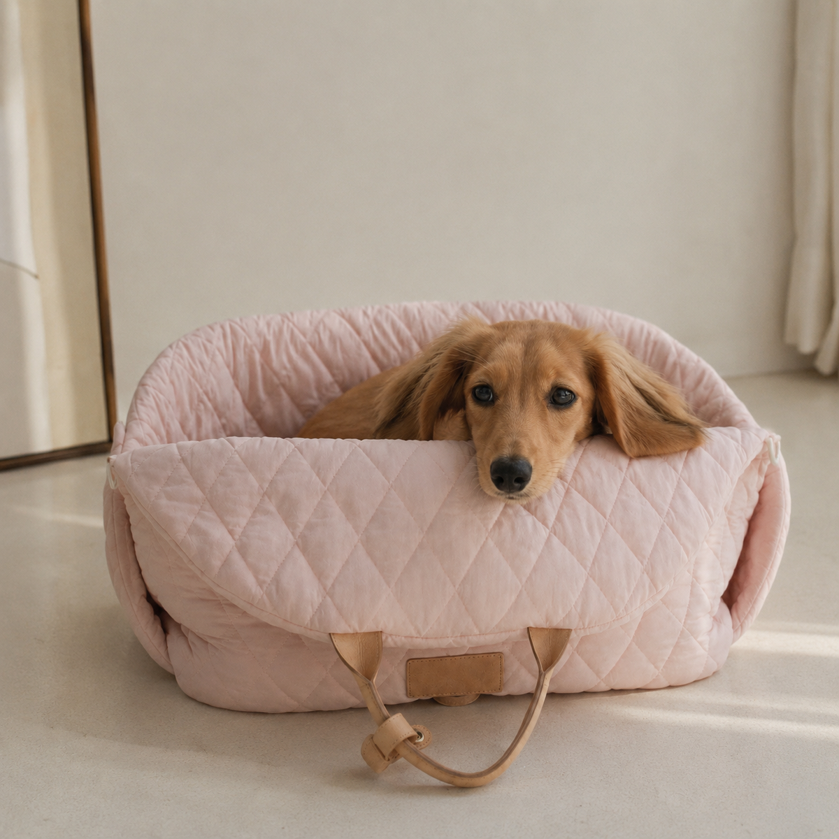 Small dog resting in a pink quilted comfort pet carrier bag
