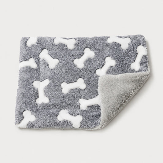 Self-warming reversible gray dog crate mat with white bone pattern