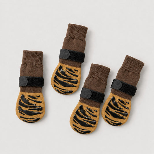 Four SteadyPaw brown and mustard dog grip socks with black non-slip traction pattern