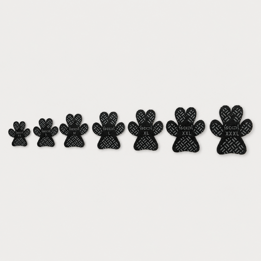 SteadyStep self-adhesive anti-slip dog paw grips shown in sizes XS through XXXL