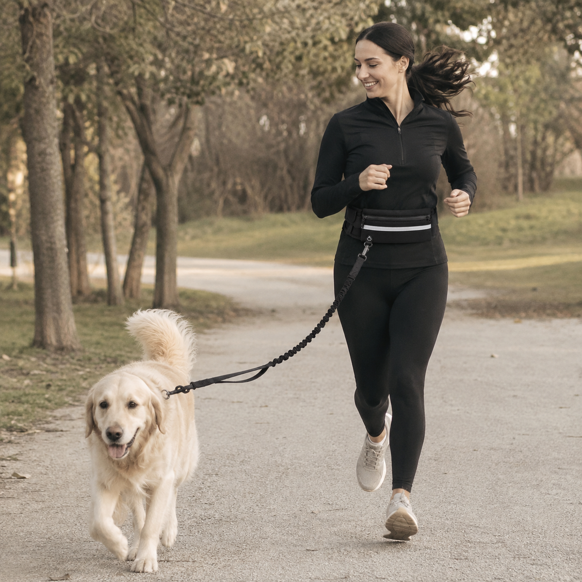 Woman running with a dog using the StrideFree hands-free dog walking belt and bungee leash