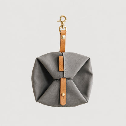Gray TrailFold waterproof foldable travel dog bowl folded with leather strap and clip