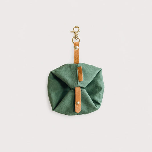 Green TrailFold waterproof foldable travel dog bowl folded with leather strap and clip